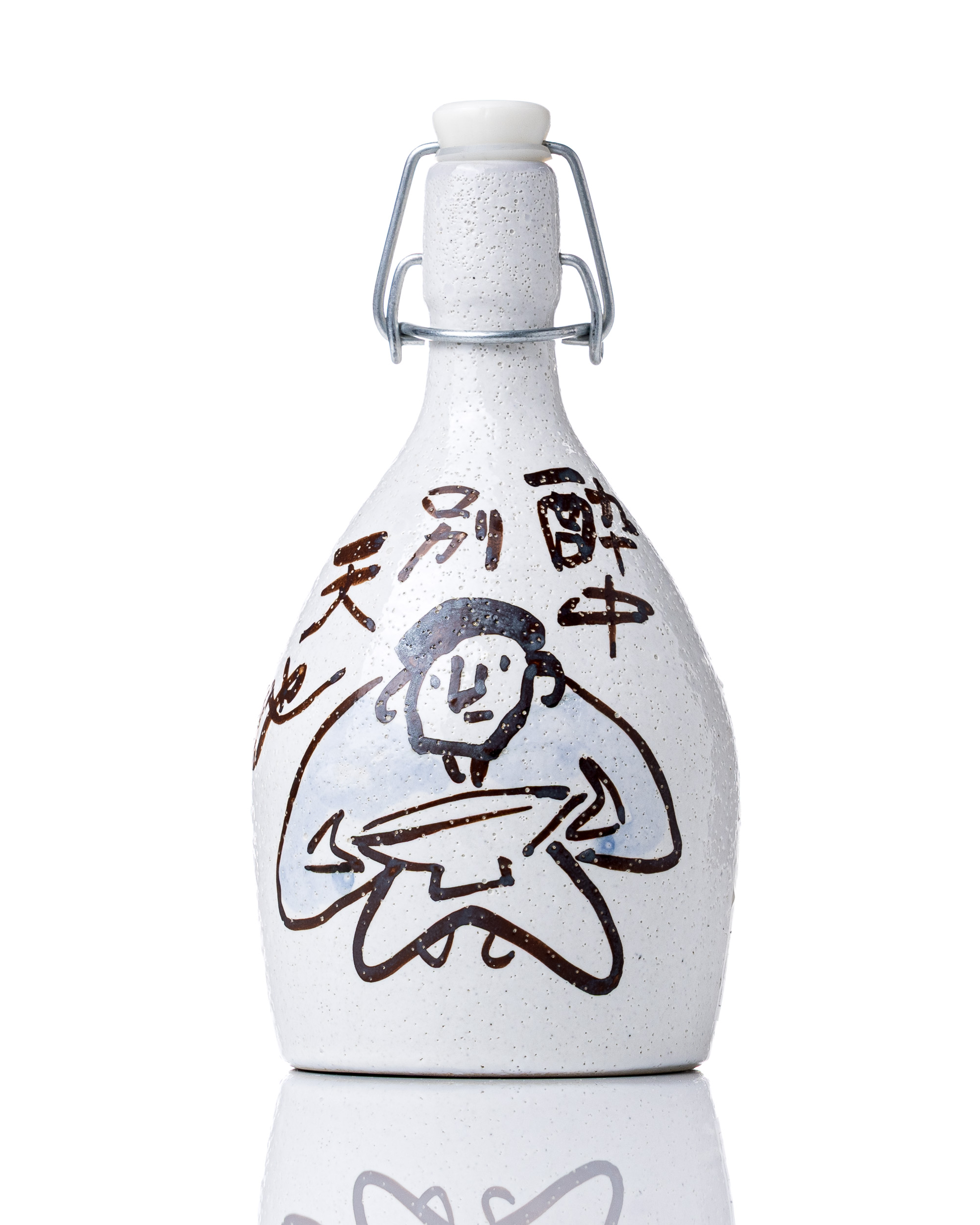 White ceramic sake bottle on a bright reflective studio surface