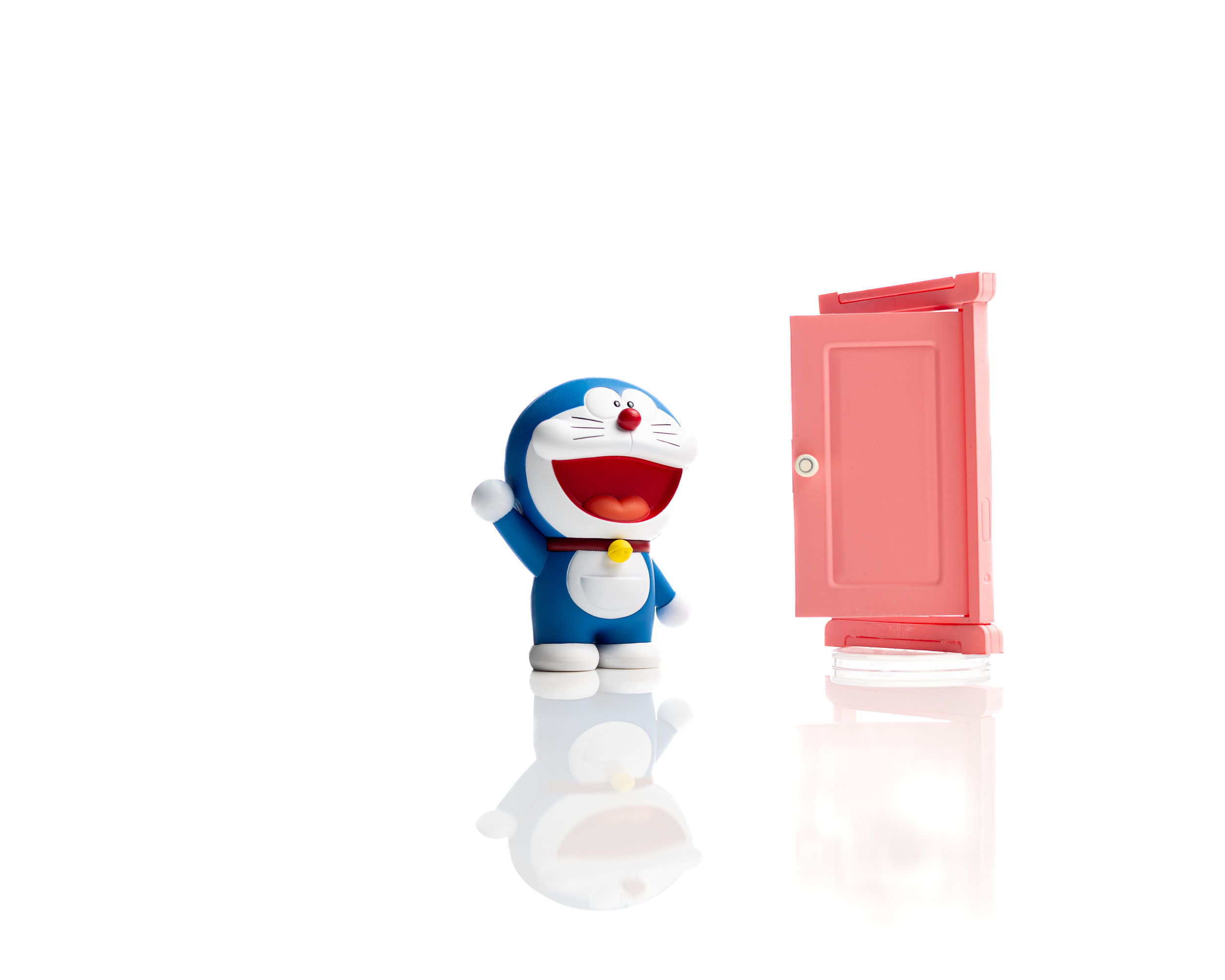 Small blue character figure and pink door on a bright reflective set